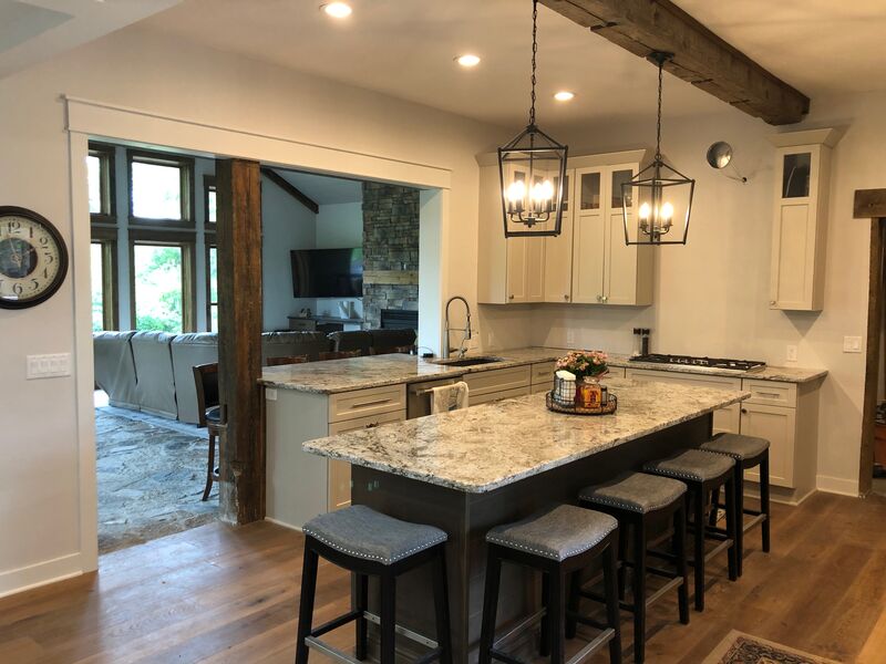Kitchen with reclaimed wood beam, granite island and lantern pendants