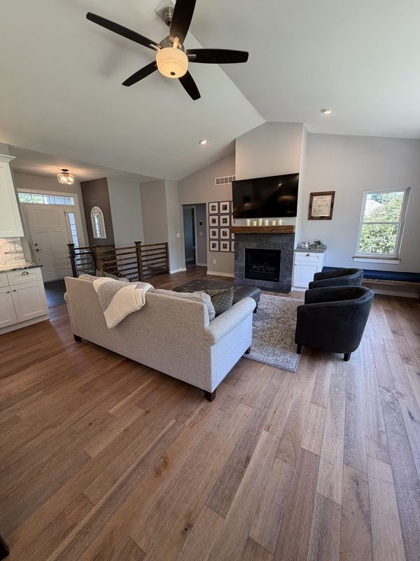 Vaulted great room with a stone fireplace and open hardwood floor plan