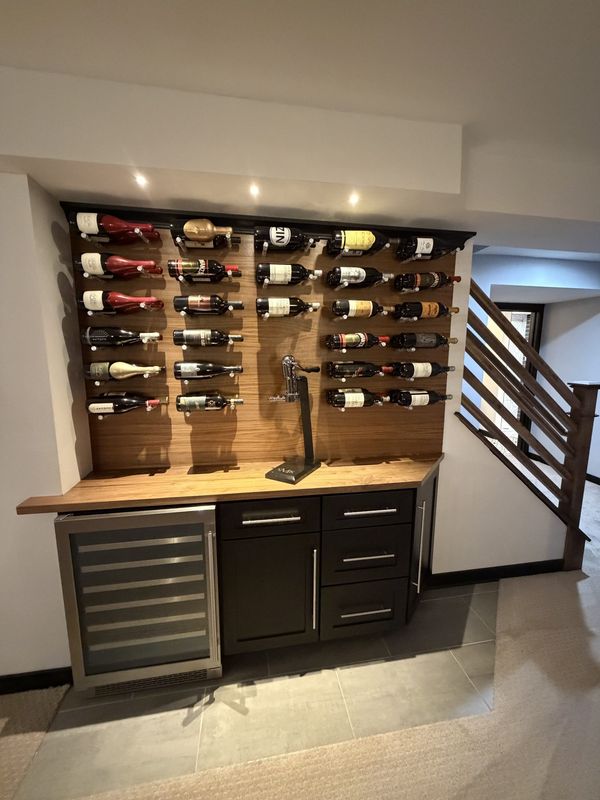 Custom wine cellar feature wall with wine storage and beverage fridge